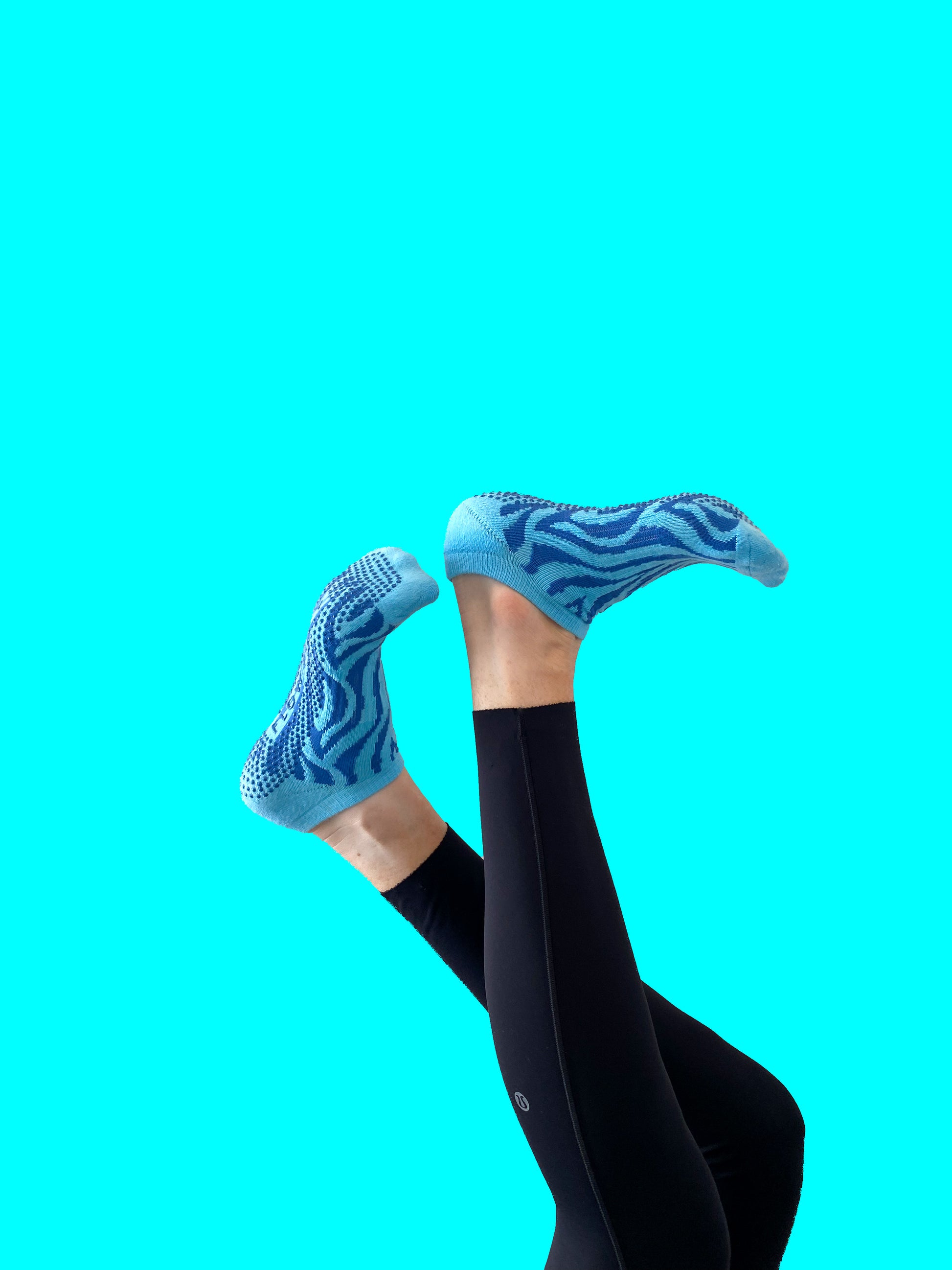 Blue pair of Flow Peppy, New Zealand made ankle pilates and yoga grip socks blue patterns.  