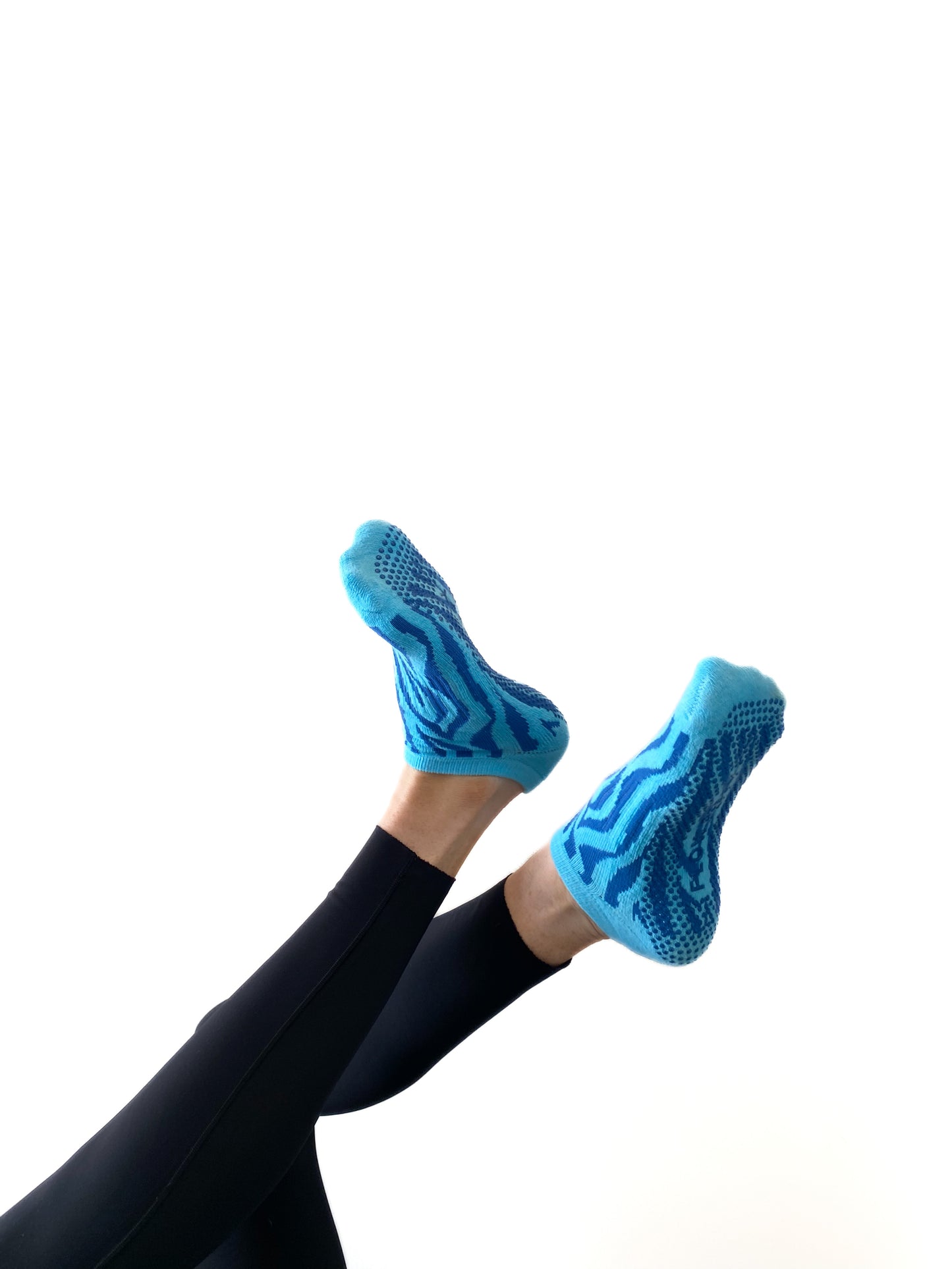 Blue pair of Flow Peppy, New Zealand made ankle pilates and yoga grip socks blue patterns.  