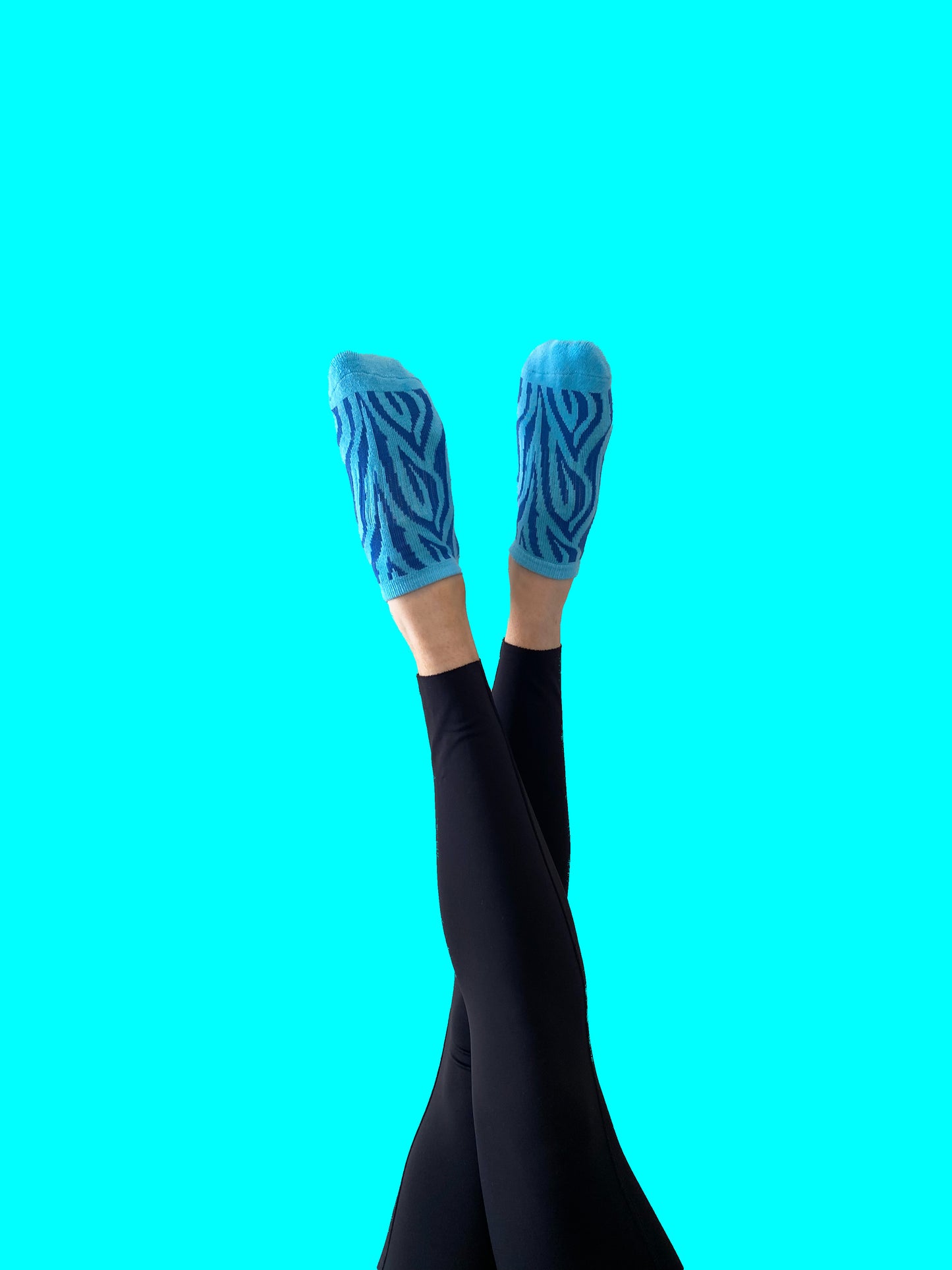 Blue pair of Flow Peppy, New Zealand made ankle pilates and yoga grip socks blue patterns.  