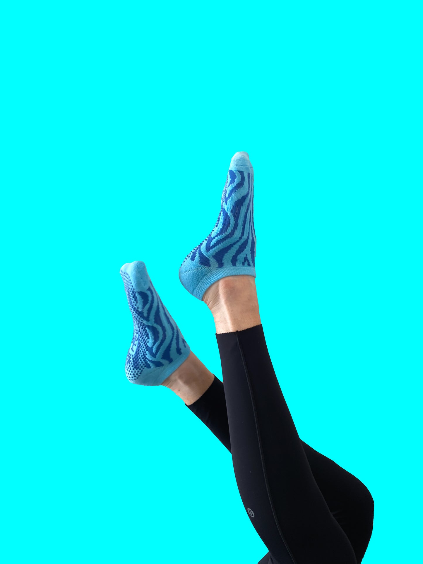 Blue pair of Flow Peppy, New Zealand made ankle pilates and yoga grip socks blue patterns.  