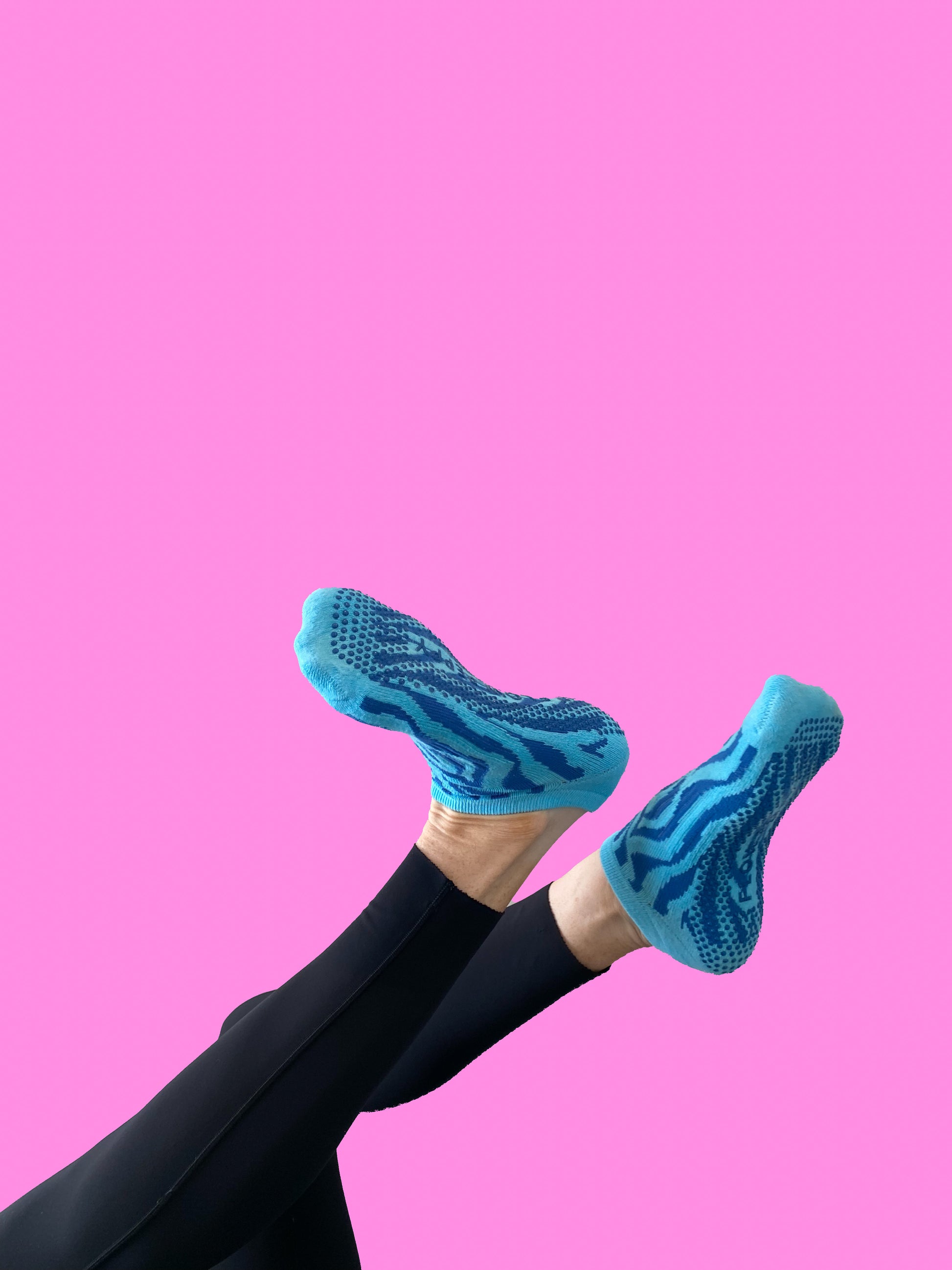 Blue pair of Flow Peppy, New Zealand made ankle pilates and yoga grip socks blue patterns.  