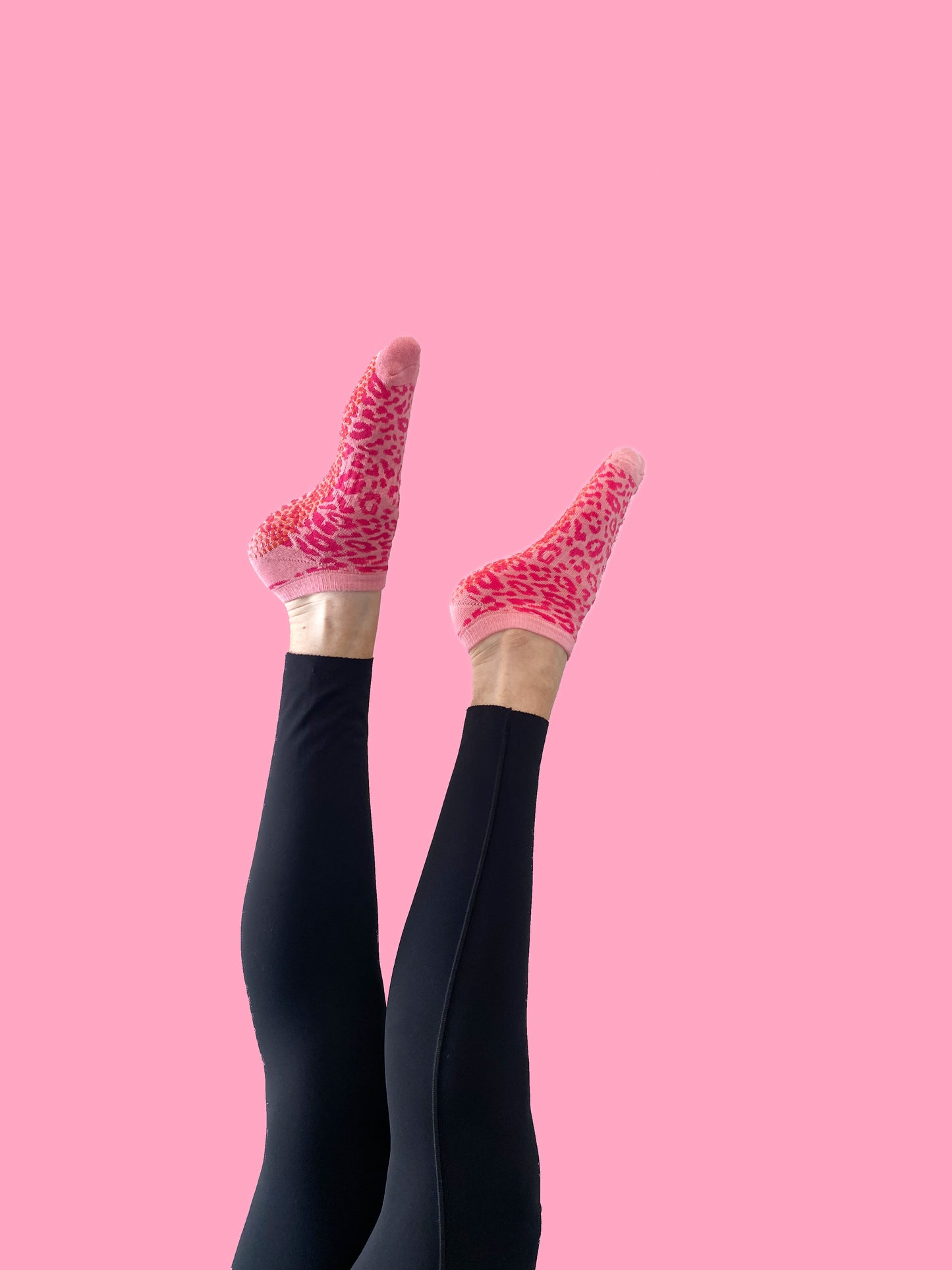 Pink cheetah Flow Peppy, made in New Zealand pilates and yoga ankle grip socks.